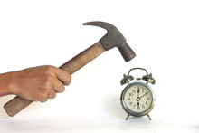 Hand Of Men Holding A Hammer Hammer To Smash The Alarm Clock Isolated On White Background Included Clipping Path.