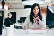 © Jacob Lund - Creative businesswoman making a phone call in the office