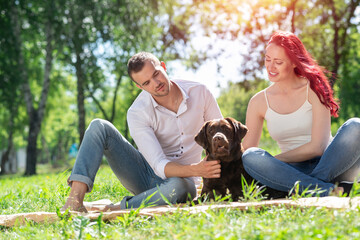 Wall Mural - Couple with a dog in the park