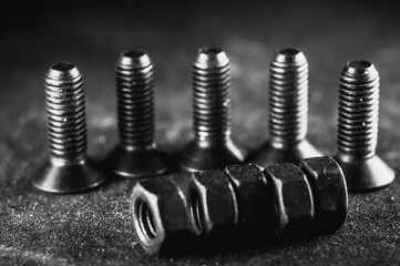 Sticker - Grayscale shot of a pile of bolts and nuts on a grunge background