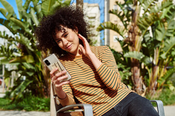 Poster - Happy young woman taking a video call outdoors