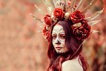 Young woman with painted skull on her face for Mexico's Day of the Dead. portrait of Calavera Catrina in red dress. Sugar skull makeup. Dia de los muertos. Day of The Dead. Halloween