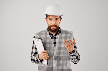 male worker in a gray vest construction work design light background