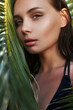 © eugenepartyzan - young sexy woman in bikini under palm tree