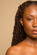 © Phiwo Ndlovu/Cultura Creative - Studio portrait of woman with braided hair