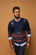 © Тарас Нагирняк - Young stylish handome indian man with backpack and laptop in glasses on background
