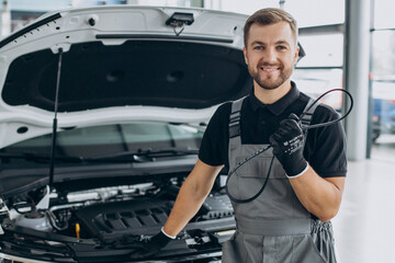 Wall Mural - Car mechanic checking up a car at a car service