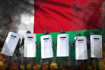 Madagascar protest fighting concept, police squad protecting order against demonstration - military 3D Illustration on flag background