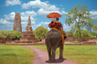 Tourists couple love on a ride elephant tour of the ancient city ayutthaya, thailand