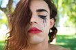 © @skuder_photographer - young latina and transsexual woman dressed in fine black lingerie. The woman is posing for the camera with her mascara smudged from crying because of discrimination. Concept diversity, transgender.