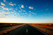 © Austockphoto - The Stuart Highway disappears into the flat horizon in central Australia.