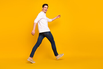 Canvas Print - Full size profile photo of funky brunet young guy run wear shirt jeans sneakers isolated on yellow color background