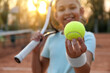 © New Africa - Cute little girl with tennis racket outdoors, focus on ball