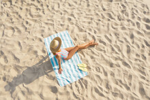 Woman Sunbathing On Beach Towel At Sandy Coast, Aerial View