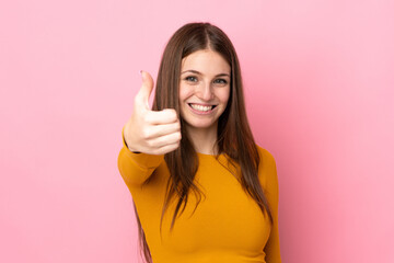 Sticker - Young caucasian woman isolated on pink background with thumbs up because something good has happened