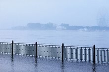 The Fence Of The City Embankment During Flooding With Water And Fog. Blagoveshchensk, Russia.