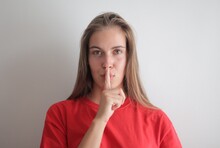 Portrait Of Young Woman With Silence Gesture