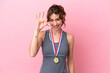 © luismolinero - Young caucasian woman with medals isolated on pink background showing ok sign with fingers