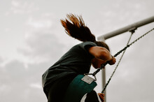 Low Angle Shot Of A Female Swinging On A Swing