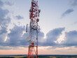 © Leonid - Telecommunication Antenna receiver on cell phone tower with 5G base station transceiver, aerial view.