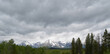 Late Spring in Grand Teton National Park: Window Peak, Traverse Peak, Rolling Thunder Mountain and Eagle Rest Peak of the Teton Range Seen From Willow Flats Overlook Under a Cloud-Filled Sky
