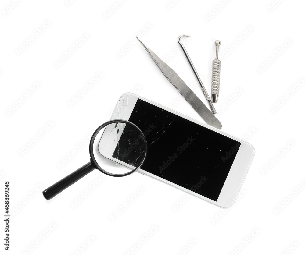 Mobile phone with broken screen, technician tools and magnifier on white background