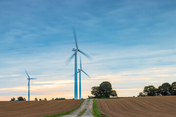 Poster - Shot of wind turbines working in rural farmland in Lubmin, Mecklenburg-Vorpommern, Germany