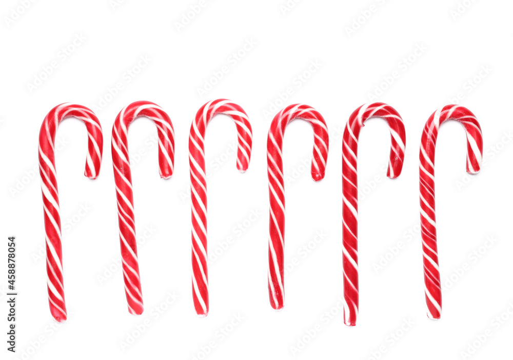 Tasty candy canes on white background