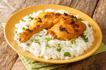 Canvas Print - Ayam Percik a Malaysian grilled chicken marinated in flavorful spices served with rice close up in the plate on the table. Horizontal