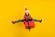 Full Length Photo Of Cheerful Little Positive Girl Jump Up Hold Hand Box Present Isolated On Yellow Color Background