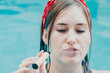 Woman smoking with electronic cigarette. Young woman smoking electronic cigarette in outdoors pool