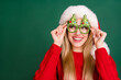 © deagreez - Portrait of attractive cheerful curious girl touching fir tree specs looking copy space winter isolated over green color background