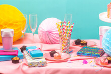 Birthday party table, with pink tablecloth