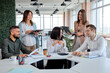 © alfa27 - Cheerful friendly business team discussing business plans strategies in modern bright office, caucasian female manager leader sit talking with co-workers. portrait, copy space. business concept