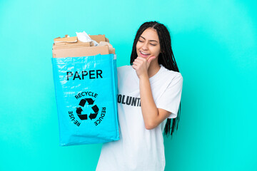 Poster - Teenager girl with braids holding a bag to recycle looking to the side and smiling