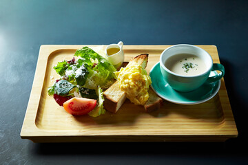 Vegetable porridge, fruit salad and bread on a wooden plate