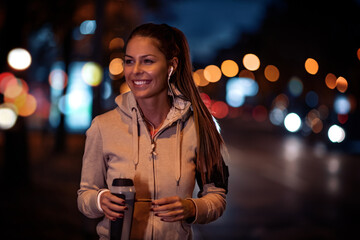 Wall Mural - Young woman running at night  in the city