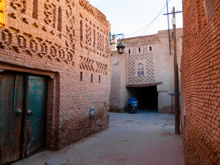 Old narrow street with brick buildings. Ouled El Hadef, Tunisia.