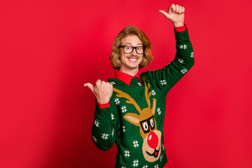 Wall Mural - Portrait of attractive cheerful guy demonstrating copy empty blank space ad isolated over bright red color background