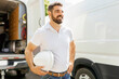 man with a hard hat standing in front of truck