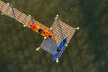 Aerial View Of A Few Canoe Standing On A Wooden Pier Along River Lagoon, Sebastian, Florida, United States.