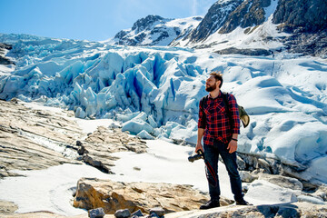 Fototapete - Man tourist with standing of great mountain Scandinavia nature