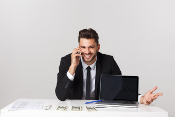 Wall Mural - Portrait of businessman talking on mobile phone in office