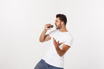 Wall Mural - Casual handsome man dancing with mobile phone isolated on white background