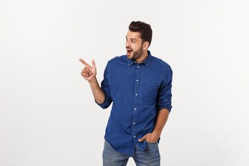 Wall Mural - Man pointing showing copy space isolated on white background. Casual handsome Caucasian young man.