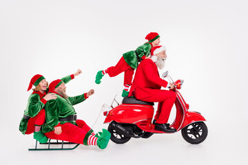 Poster - Portrait of attractive cheerful four people riding scooter sledge December time isolated over white color background