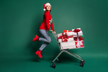 Poster - Full body profile photo of sweet young lady with trolley jump wear sweater cap jeans boots isolated on green background