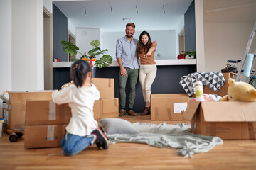 Wall Mural - family- mother father and girl move to new apartment and unpack boxes