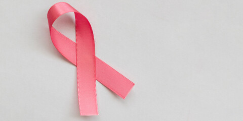 pink bow from the breast cancer prevention campaign. pink October. space for text