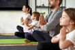 © Svitlana - Crop of family with kids practice yoga meditate
